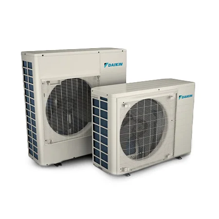 Two white Daikin outdoor air conditioning units with visible vents and fans, positioned side by side against a plain white background.